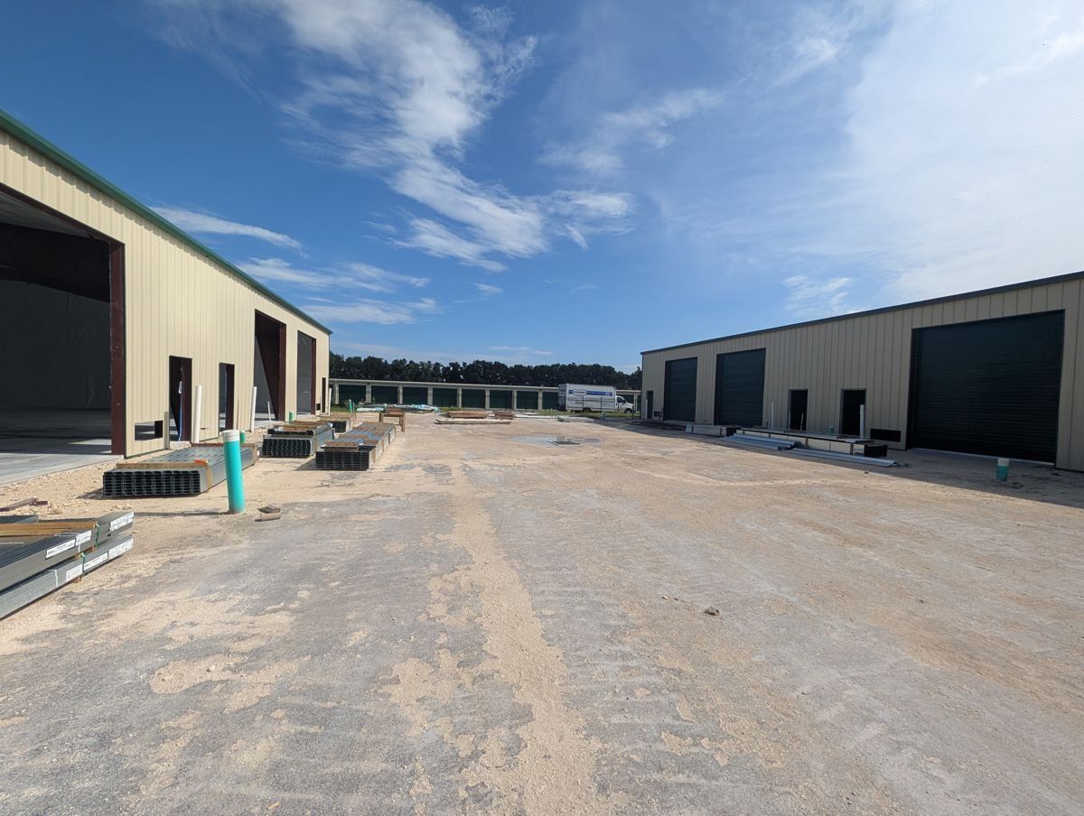Metal flex buildings with 12x14 overhead doors facing a graded truck court.